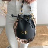 Bombonera piel negro arandelas doradas iniciales bordadas