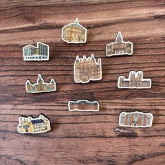 The ally mckay buildings wooden pin badge collection features 9 buildings from across the University.